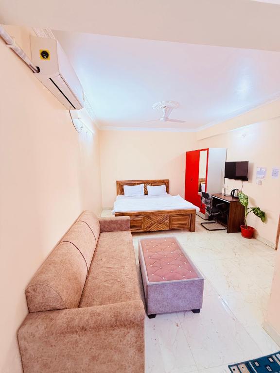 a living room with a couch and a bed at AeroStay Comfort Inn - Near Ranchi Airport in Rānchī