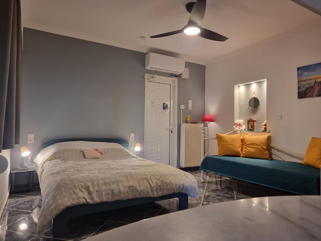 a bedroom with a bed and a couch at Isthmus Cuddly Nest in Isthmia