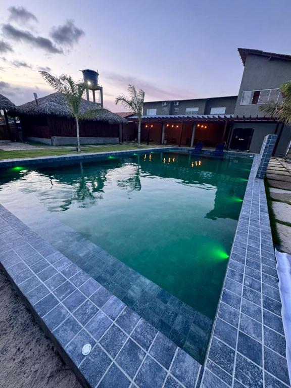 a swimming pool with green lights in a building at POUSADA AMORIM in Santo Amaro