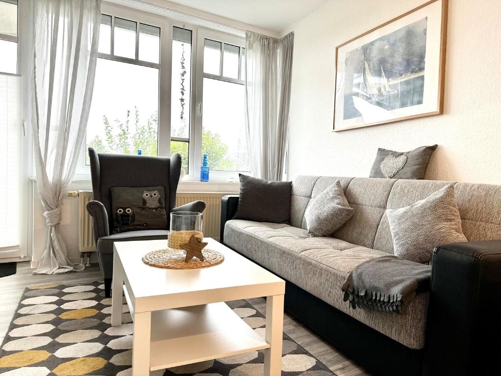 a living room with a couch and a table at Ferienwohnung De Priel in Dorum-Neufeld