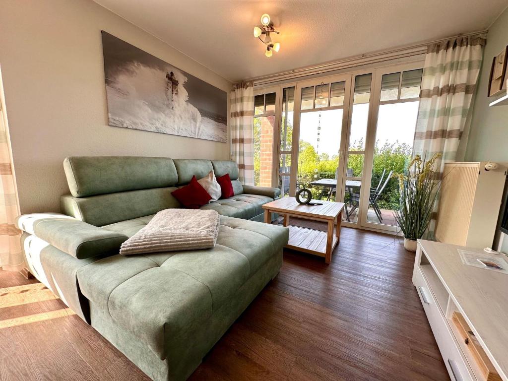 a living room with a couch and a table at Ferienwohnung de Drift in Dorum-Neufeld