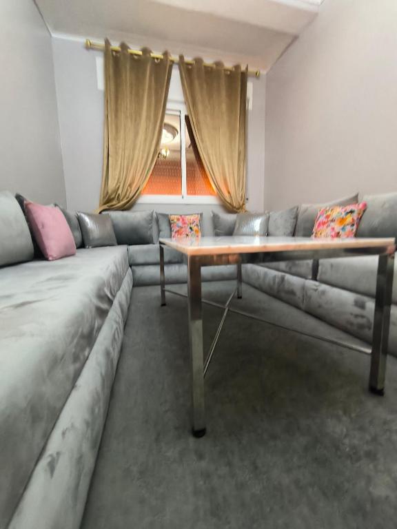 a living room with a couch and a table at Younes residence in Asilah