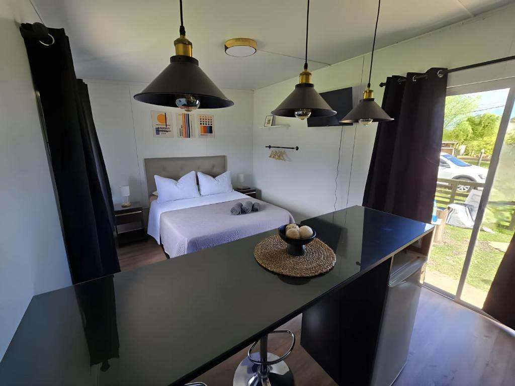a bedroom with a bed and a desk with a table at Maridalba 2 in La Coronilla