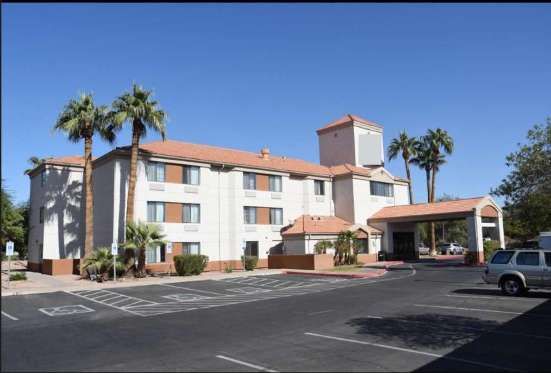 a hotel with a parking lot in front of it at Sky Harbor Airport Inn in Phoenix