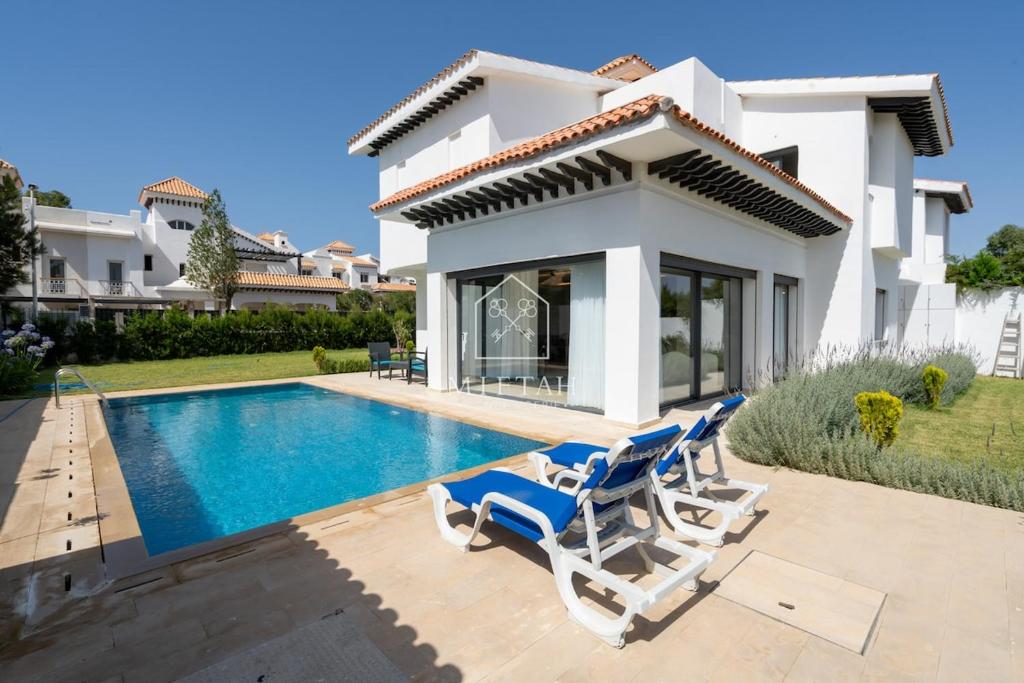 a villa with a swimming pool and two lounge chairs at Luxury Villa with Private Pool STR1 in Tangier