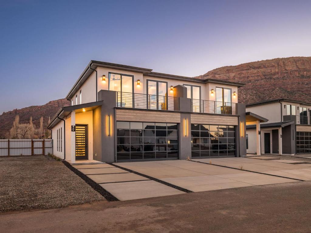 a large house with a mountain in the background at Modern Luxury at Copper View Moab in Moab