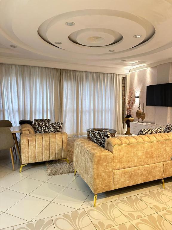 a living room with two couches and a table at LuX EXECUTIVE 2 BEDROOM in Eldoret