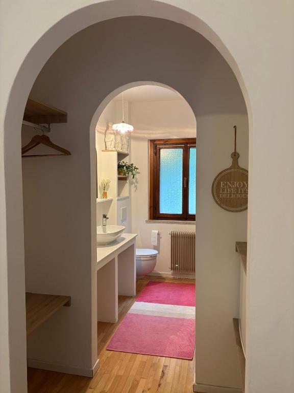 an archway in a bathroom with a sink and a toilet at L'Intermezzo in Venzone