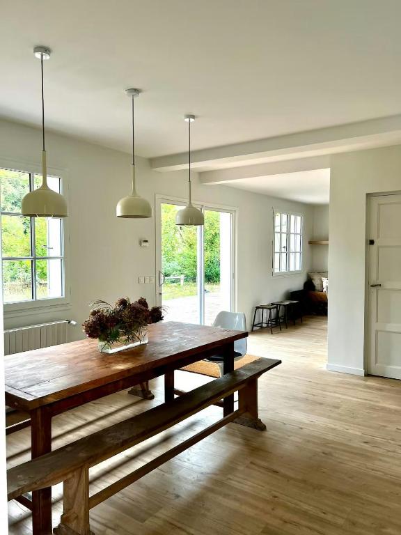 a living room with a wooden table with flowers on it at Charming House In Lyons-La-Forêt in Lyons-la-Forêt