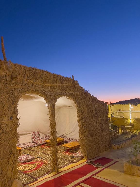 a tent that is made out of sticks at لودج ادرار احكيك in Siwa