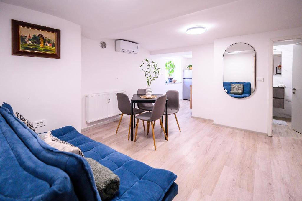a living room with a blue couch and a table at The LOFT Apartments Ljubljana in Ljubljana