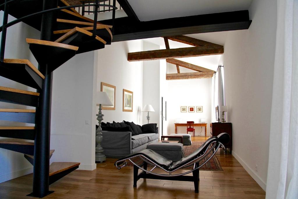 a living room filled with furniture and a staircase at Le Couvent Marseille in Marseille