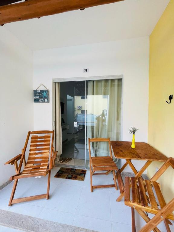 a dining room with a wooden table and chairs at Praia dos Corais apt 79 in Santa Cruz Cabrália