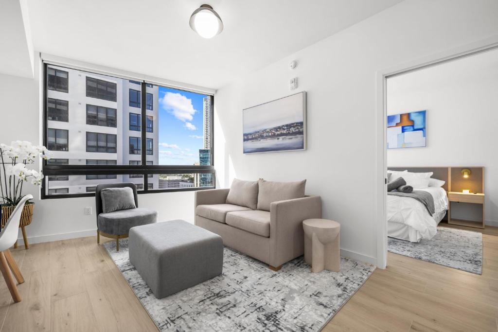 a living room with a couch chair and a bed at Downtown Miami - Rooftop Pool & Gym in Miami