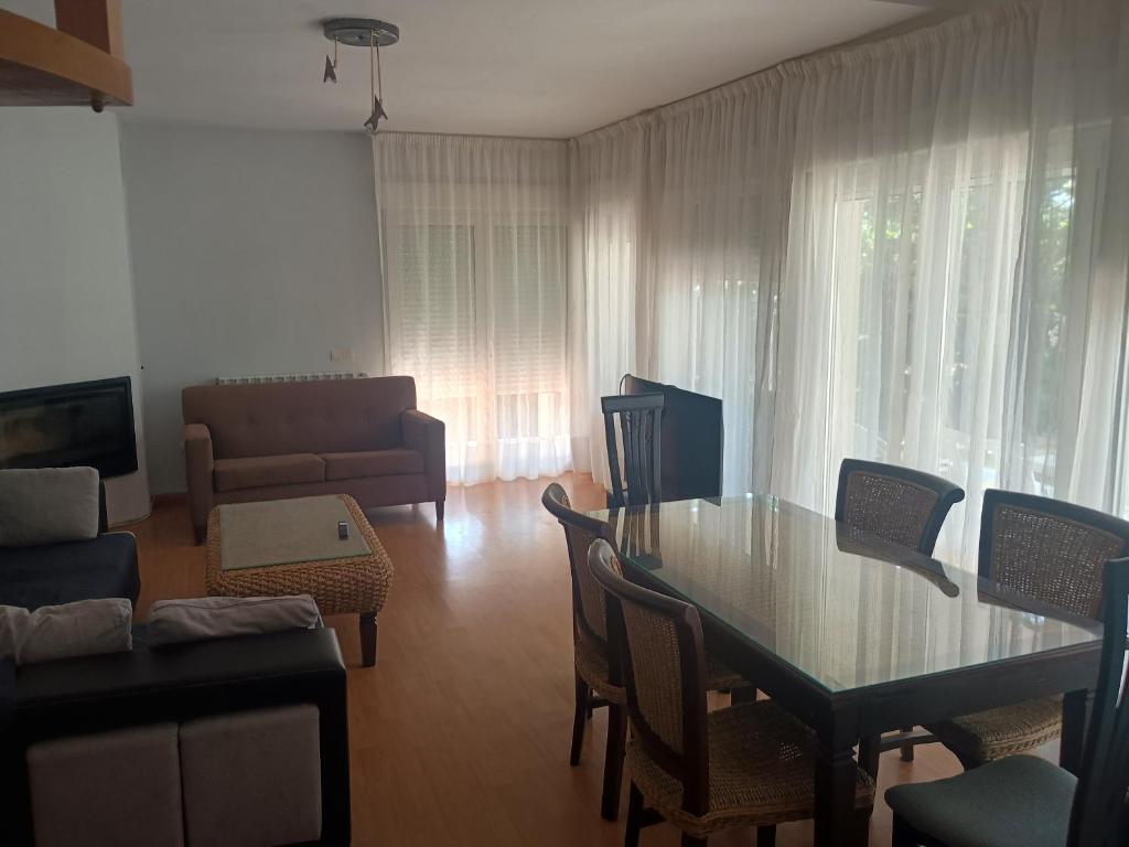 a living room with a table and chairs and a couch at Chalet en Sieteiglesias, Sierra Norte de Madrid in Sieteiglesias