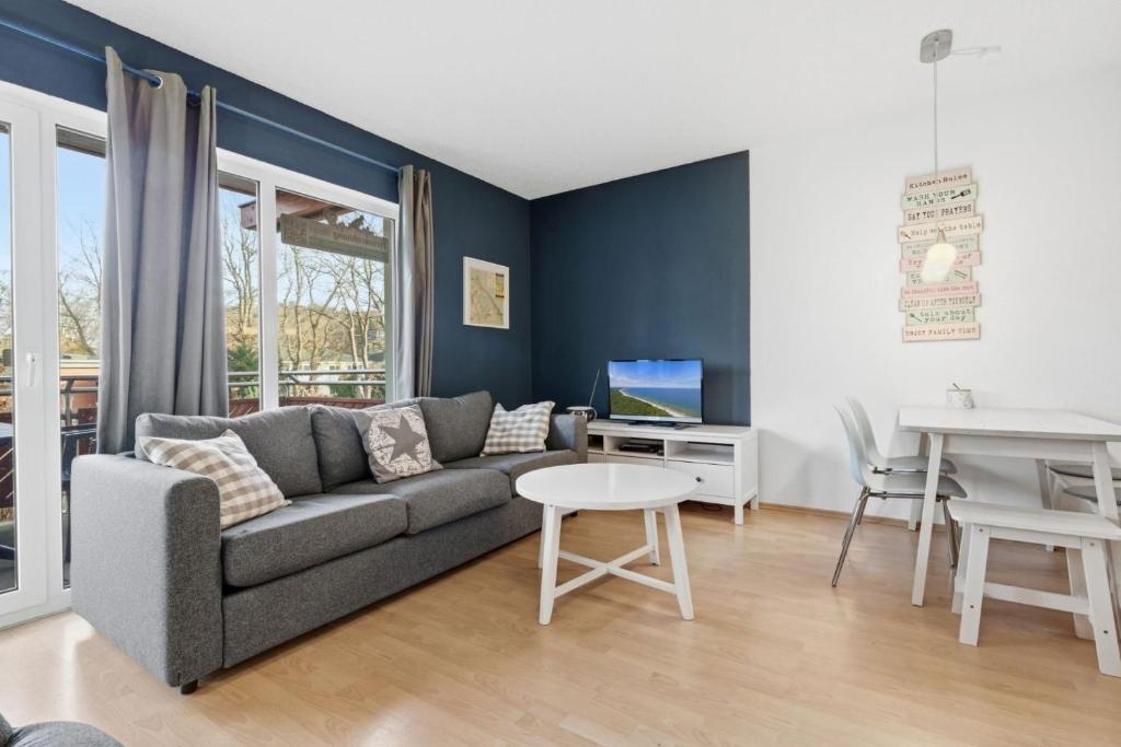a living room with a couch and a table at Fewo Henri in Zempin