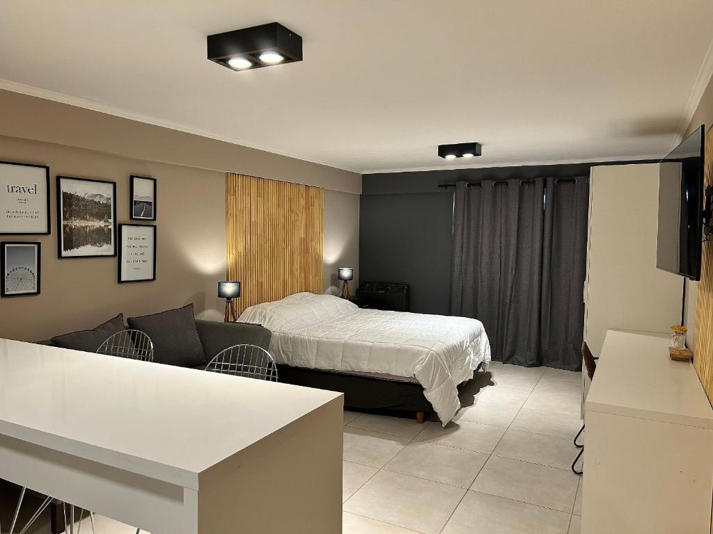 a hotel room with a bed and a couch at 4 Estaciones in El Bolsón