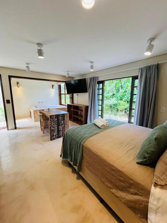 a bedroom with a bed and a pool table at Studio com Jacuzzi na Natureza Casal Baoba Suite in Bombinhas