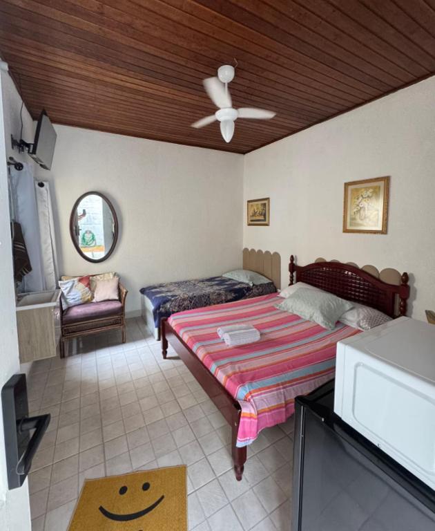 a bedroom with a bed and a ceiling fan at SuÍte 4 com Ar Condicionado, Wi-Fi e Netflix in Jundiaí