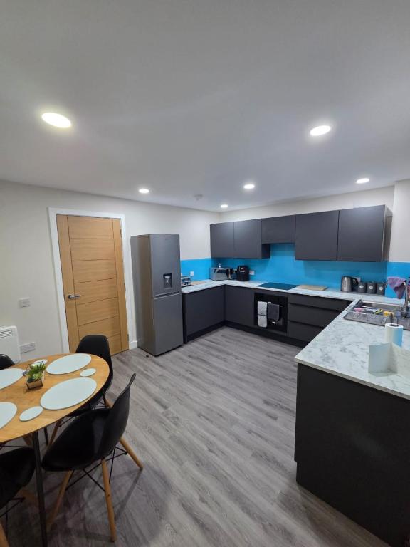 a large kitchen with a table and a table and chairs at 25 Colliers Road,Stirling in Plean Station