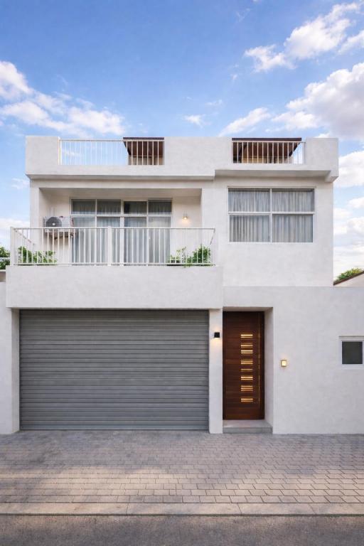 a white house with a garage at Aranya Heights Luxury 7 Pax Home in Wattala