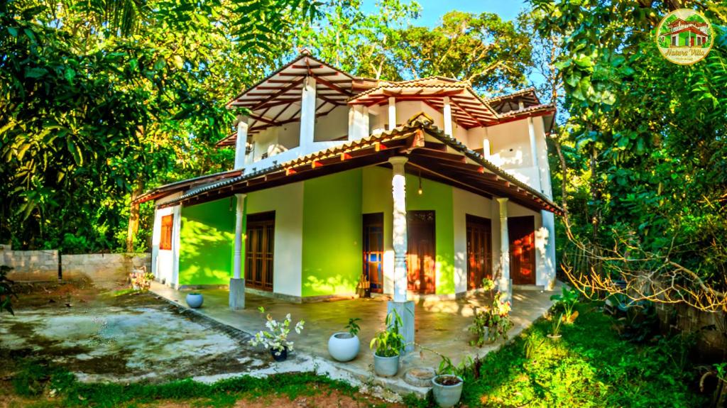 a green house with plants in front of it at Natura Villa in Hiriketiya