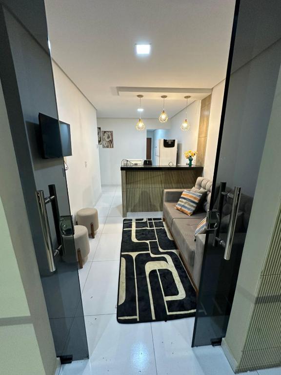a living room with a couch and a rug at Flat JK em Dona Inês-pb in Dona Inês