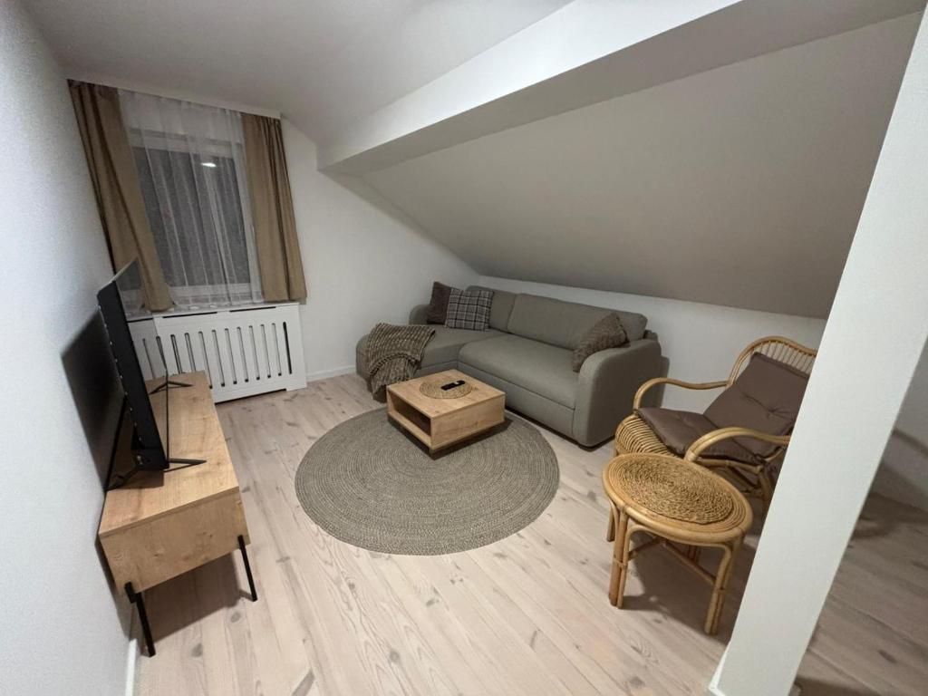 a living room with a couch and a tv at Duplex House - Private Home MUNA in Sarajevo