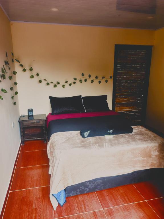 a bedroom with a large bed in a room at Cabañas el guadual in La Vega