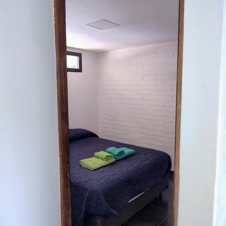 a mirror reflection of a bed in a room at Departamento 8 in El Bolsón