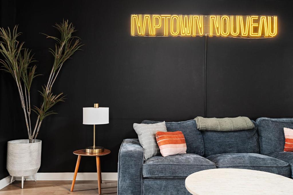 a living room with a blue couch and a black wall at Indy Getaway - Near Downtown Indy - Sleeps 10! in Indianapolis