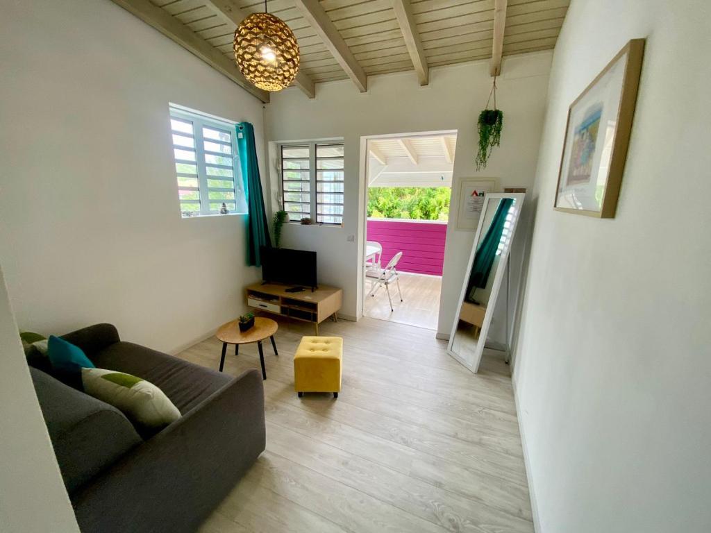 a living room with a couch and a table at Grand Case Beach Steps in Grand Case