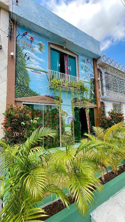 a blue building with a mural on the side of it at O Plácido Arte Hostel in Belém