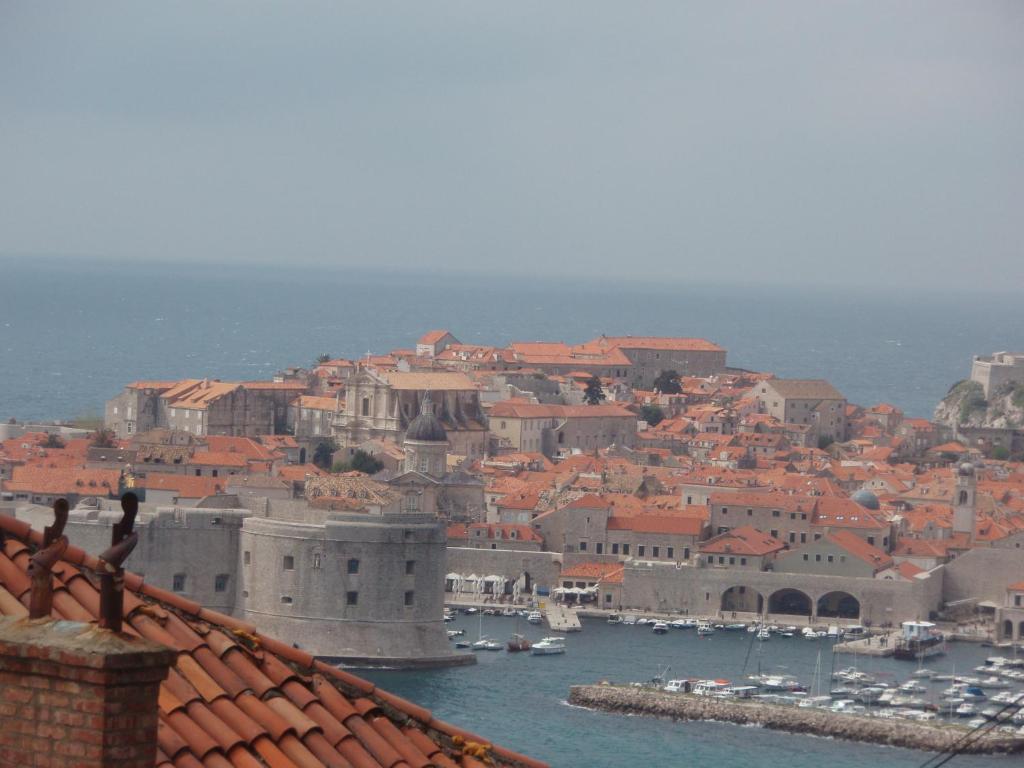 a view of a city with a harbor with boats at Apartment Karmen in Dubrovnik