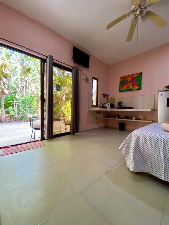 a bedroom with a bed and a ceiling fan at Casa Tio 1,quiet ground floor apartment in El Cuyo