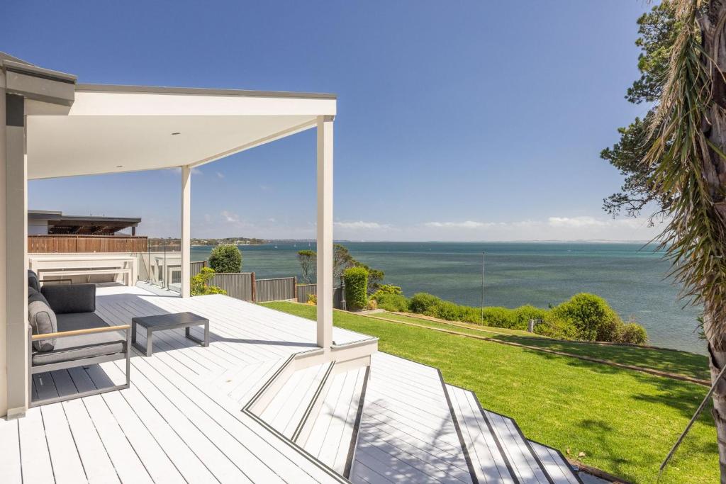 a view of the ocean from the deck of a house at Cliff Top Retreat in San Remo