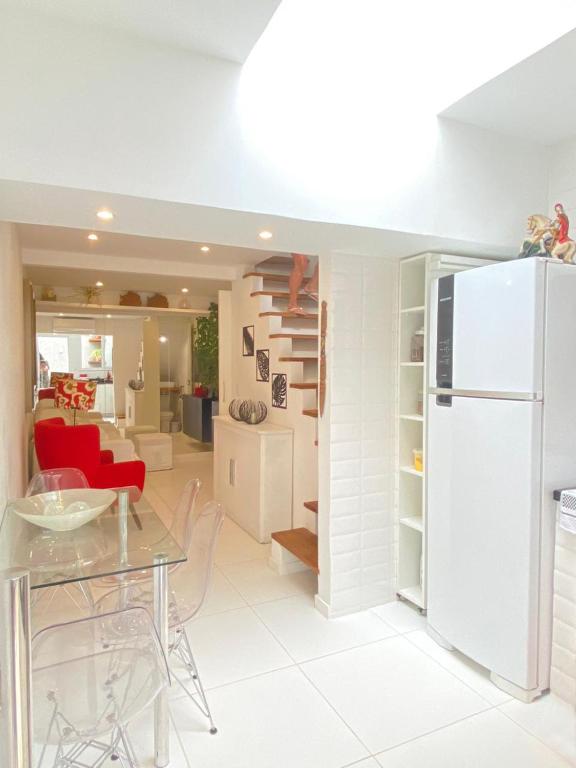 a kitchen and living room with a white refrigerator at MATER Vila Borges in Rio de Janeiro