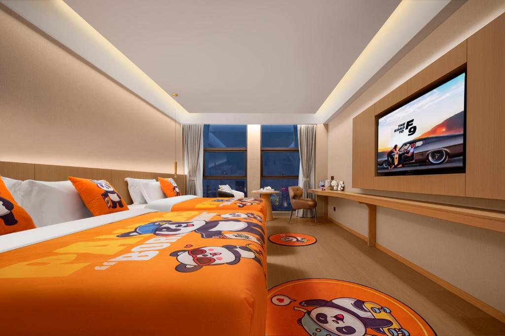 a hotel room with a bed and a flat screen tv at Surprise Hotel Chengdu in Chengdu