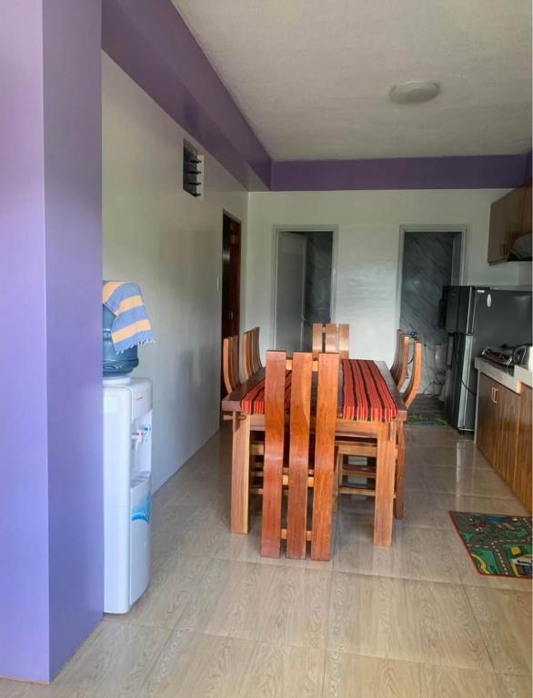 a kitchen with a table and chairs in a room at Harmony Mines in Baguio