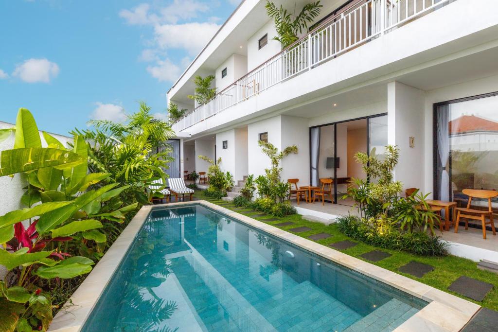 an image of a villa with a swimming pool at Famiglie Guest House in Canggu