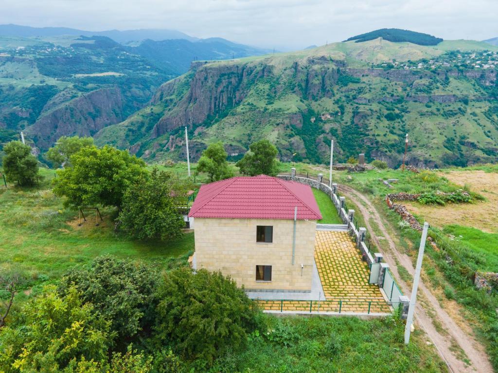 a building with a red roof on a mountain at Canyon View Dsegh in Dsegh