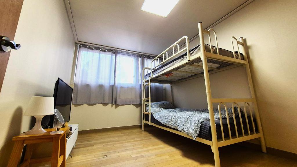 a bedroom with two bunk beds and a desk at Nick's home01 in Ilsan-ni