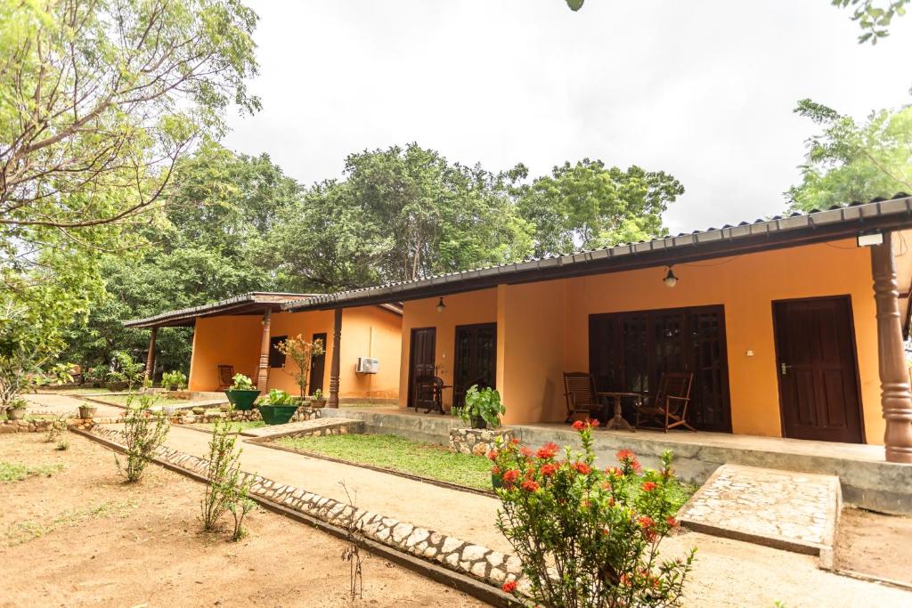 a house with a garden in front of it at Elephant Path by Alpine Resorts in Habarana