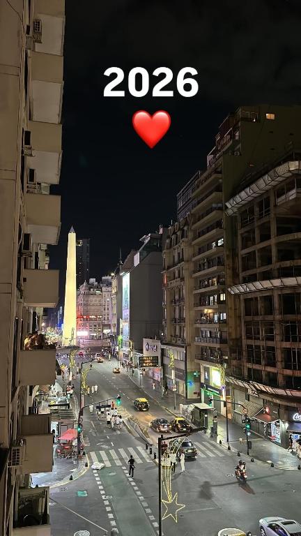 a city at night with a heart in the sky at Av corrientes 1 in Buenos Aires
