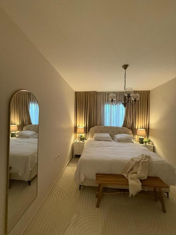 a bedroom with a large bed and a mirror at Shemesh Boutique in Beit Shemesh