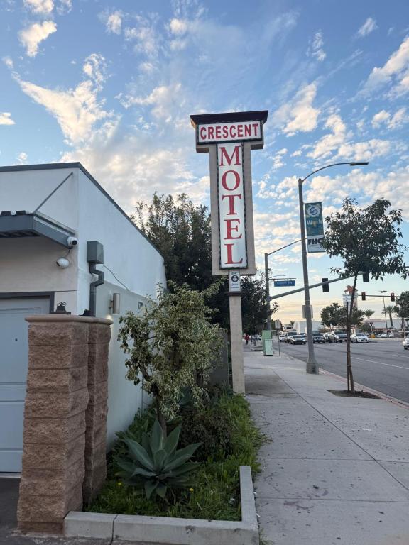 a sign for a gas station on a street at Crescent Motel, South Gate - Los Angeles in South Gate