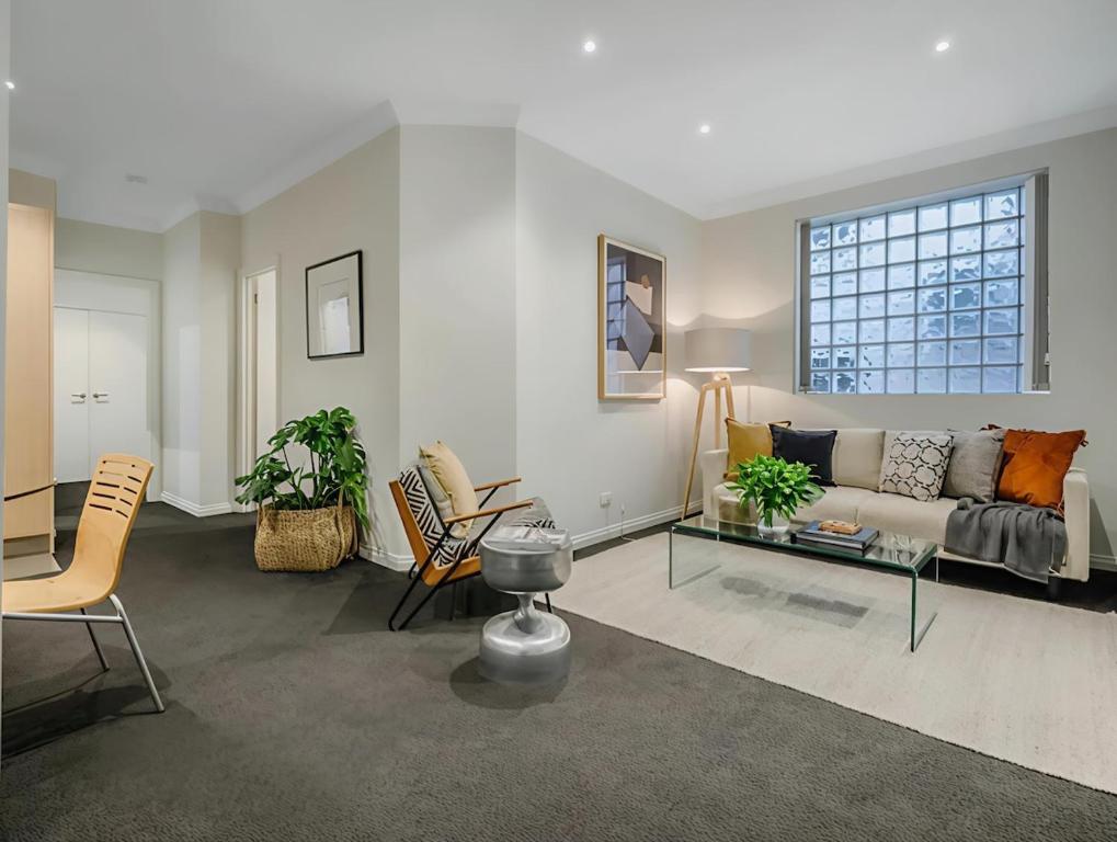 a living room with a couch and a table at Hobart Central Retreat in Hobart