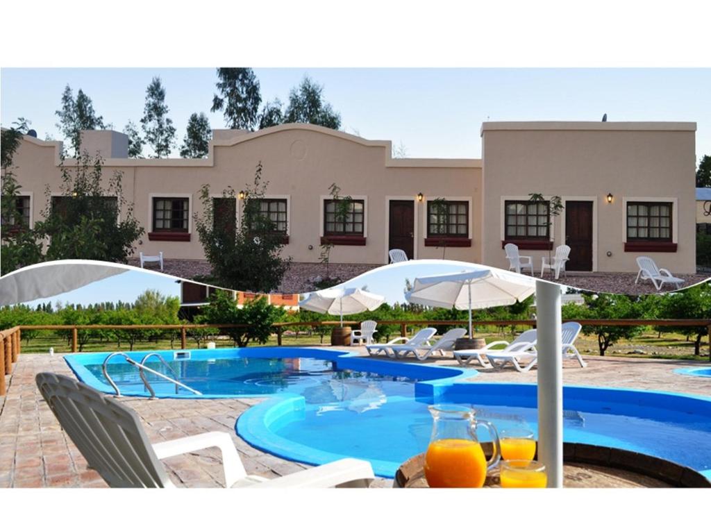 a swimming pool in front of a building at Posada San Vicente in San Rafael