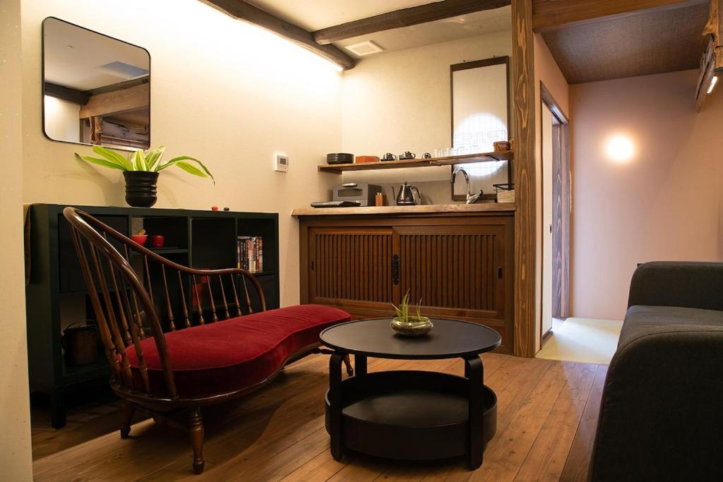 a living room with a chair and a table at 瓦町家kawaramachiya in Takamatsu