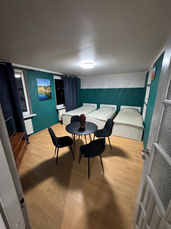 a living room with a couch and a table and chairs at Mieszkaj U Marty in Jaworzno